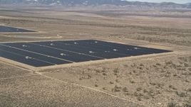 5K aerial stock footage of a solar panel array in the desert of Antelope Valley, California Aerial Stock Footage | AX0005_076E