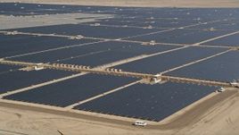 5K aerial stock footage of circling solar panels at a solar energy farm in the Mojave Desert, California Aerial Stock Footage | AX0005_088E