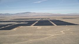 5K aerial stock footage of a reverse view of a solar energy farm in the Mojave Desert, California Aerial Stock Footage | AX0005_094