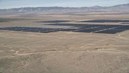5K aerial stock footage of fly over desert mountain and reveal solar energy array in the Mojave Desert, California Aerial Stock Footage | AX0005_097