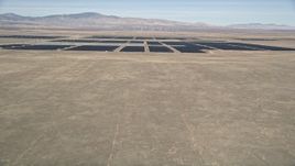 5K aerial stock footage fly over desert hill to reveal vast solar energy array in Antelope Valley, California Aerial Stock Footage | AX0005_100