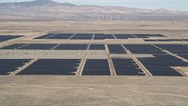 5K aerial stock footage fly low over desert hill and reveal solar array in Antelope Valley, California Aerial Stock Footage | AX0005_102
