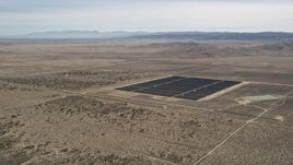 5K aerial stock footage orbit small group of panels at a solar energy array in the Mojave Desert, California Aerial Stock Footage | AX0005_114