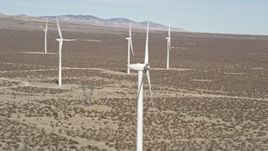 5K aerial stock footage orbit top of a windmill in the Mojave Desert, California Aerial Stock Footage | AX0005_129E