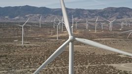 5K aerial stock footage orbit of a windmill at a desert wind farm in Antelope Valley, California Aerial Stock Footage | AX0005_131E