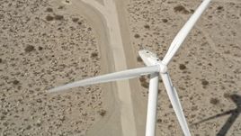 5K aerial stock footage fly over blades of a windmill in the Mojave Desert, California Aerial Stock Footage | AX0005_134