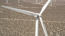 5K aerial stock footage of orbit spinning windmill blades in Mojave Desert of California Aerial Stock Footage | AX0005_136E