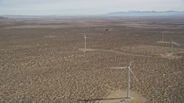 5K aerial stock footage of a small group of windmills at a Mojave Desert wind farm in California Aerial Stock Footage | AX0005_140