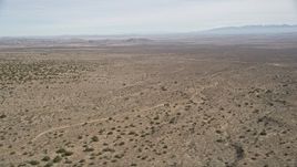 5K aerial stock footage of passing by open desert in Antelope Valley, California Aerial Stock Footage | AX0005_146