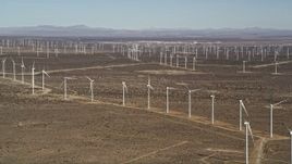 5K aerial stock footage pan to line of windmills at large wind farm in the Mojave Desert, California Aerial Stock Footage | AX0006_008E