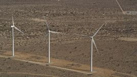 5K aerial stock footage approach a pair of windmills at a desert wind farm in Antelope Valley, California Aerial Stock Footage | AX0006_010