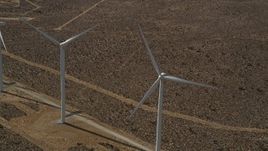 5K aerial stock footage of orbiting a pair of windmills in the desert in Antelope Valley, California Aerial Stock Footage | AX0006_011E