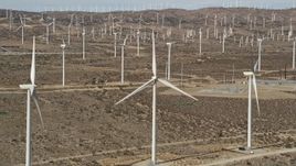 5K aerial stock footage orbit a windmill at a desert wind farm in Antelope Valley, California Aerial Stock Footage | AX0006_014