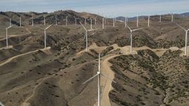 5K aerial stock footage of approaching windmills at a desert wind energy farm in Antelope Valley, California Aerial Stock Footage | AX0006_022E