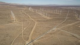 5K aerial stock footage approach three rows of windmills at a wind energy farm in the California desert Aerial Stock Footage | AX0006_048