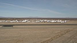 5K aerial stock footage of a low altitude orbit of planes at an aircraft boneyard in the desert, Mojave Air and Space Port, California Aerial Stock Footage | AX0006_057