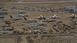 5K aerial stock footage orbiting jet aircraft at an airplane boneyard in the Mojave Desert, California Aerial Stock Footage | AX0006_063