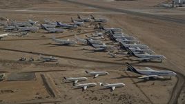 5K aerial stock footage orbit a group of aircraft at a boneyard in the Mojave Desert, California Aerial Stock Footage | AX0006_064E