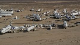5K aerial stock footage of rows of airplanes at an aircraft boneyard in the Mojave Desert, California Aerial Stock Footage | AX0006_066E