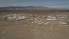 5K aerial stock footage orbit airplanes in a desert field at an aircraft boneyard, Mojave Air and Space Port, California Aerial Stock Footage | AX0006_069