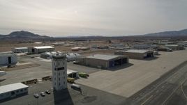 5K aerial  video of passing control tower and hangars at Mojave Air and Space Port in California Aerial Stock Footage | AX0006_070