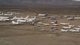 5K aerial stock footage orbit large and small jets at a desert aircraft boneyard in Mojave Air and Space Port, California  Aerial Stock Footage | AX0006_072