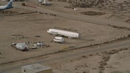 5K aerial stock footage orbit the cabin part of an airplane at a boneyard in the California desert, Mojave Air and Space Port Aerial Stock Footage | AX0006_073