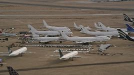 5K aerial stock footage of jet airplanes and components at an aircraft boneyard in the desert, Mojave Air and Space Port, California Aerial Stock Footage | AX0006_076