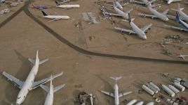 5K aerial stock footage fly over several jet airplanes at an aircraft boneyard in the Mojave Desert, California Aerial Stock Footage | AX0006_079E