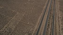 5K aerial stock footage reverse view of a Highway 14 and open desert in Antelope Valley, California Aerial Stock Footage | AX0006_099