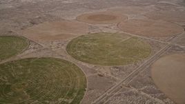 5K aerial stock footage orbit circular crop fields in the Mojave Desert, California Aerial Stock Footage | AX0006_107