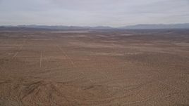 5K aerial stock footage pan across open desert and mountains in the Mojave Desert, California Aerial Stock Footage | AX0006_118