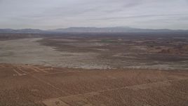 5K aerial stock footage tilt up to reveal a dry lake in the Mojave Desert, California Aerial Stock Footage | AX0006_130