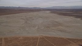 5K aerial stock footage descend toward a dry lake in the Mojave Desert, California Aerial Stock Footage | AX0006_131E