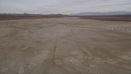 5K aerial stock footage of flying low altitude over a desert dry lake, El Mirage Lake, California Aerial Stock Footage | AX0006_134E