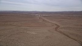 5K aerial stock footage pan across the Mojave Desert to reveal the small town of Helendale, California Aerial Stock Footage | AX0006_156