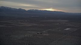 5K aerial stock footage of rural desert community near mountains with light snow at Sunset, California Aerial Stock Footage | AX0007_023
