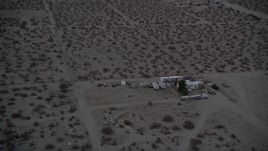 5K aerial stock footage tilt and fly over RVs parked in the Mojave Desert at twilight, California Aerial Stock Footage | AX0007_024