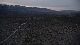 5K aerial stock footage approach isolated home while flying over the Mojave Desert at twilight, California Aerial Stock Footage | AX0007_044