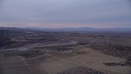 5K aerial stock footage approach a dry riverbed at twilight in the Mojave Desert, California Aerial Stock Footage | AX0008_002