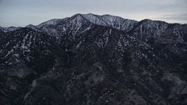 5K aerial stock footage approach snowy ridges in the San Gabriel Mountains in winter at twilight, California Aerial Stock Footage | AX0008_006