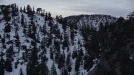 5K aerial stock footage approach and fly over snowy ridge in the San Gabriel Mountains at twilight, California Aerial Stock Footage | AX0008_011