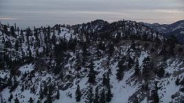 5K aerial stock footage approach and fly over ridges with winter snow in the San Gabriel Mountains, California, twilight Aerial Stock Footage | AX0008_013