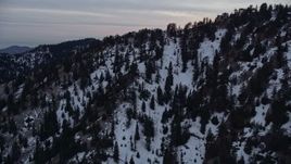 5K aerial stock footage orbit slopes with winter snow in the San Gabriel Mountains at twilight, California Aerial Stock Footage | AX0008_015
