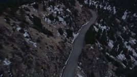 5K aerial stock footage fly over mountain road with winter snow in the San Gabriel Mountains at twilight, California Aerial Stock Footage | AX0008_017