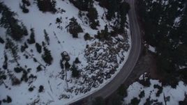 5K aerial stock footage bird's eye of mountain road with winter snow through San Gabriel Mountains at twilight, California Aerial Stock Footage | AX0008_027