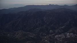 5K aerial stock footage tilt up and approach San Gabriel Mountains at twilight, California Aerial Stock Footage | AX0008_036
