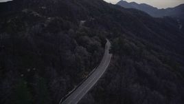 5K aerial stock footage follow winding mountain road in the San Gabriel Mountains at twilight, California Aerial Stock Footage | AX0008_041E