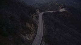 5K aerial stock footage follow lonely road at twilight through the San Gabriel Mountains, California Aerial Stock Footage | AX0008_043E