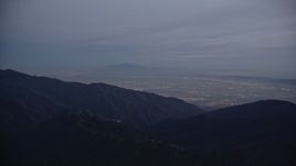 5K aerial stock footage video of San Gabriel Valley beyond the mountains at twilight, California Aerial Stock Footage | AX0008_048
